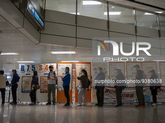 People lining up next to signs for the Sinovac CoronaVac Inactivated Vaccine by China Biotechnology company, Sinovac Biotech Ltd.,at a Covid...