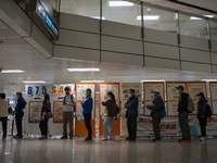 People lining up next to signs for the Sinovac CoronaVac Inactivated Vaccine by China Biotechnology company, Sinovac Biotech Ltd.,at a Covid...