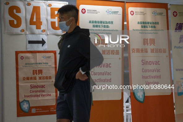 A man walks pass signs for the Sinovac CoronaVac Inactivated Vaccine by China Biotechnology company, Sinovac Biotech Ltd.,at a Covid-19 vacc...