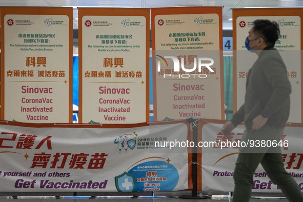 A man walks pass signs for the Sinovac CoronaVac Inactivated Vaccine by China Biotechnology company, Sinovac Biotech Ltd.,at a Covid-19 vacc...