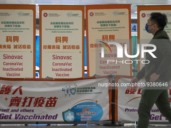 A man walks pass signs for the Sinovac CoronaVac Inactivated Vaccine by China Biotechnology company, Sinovac Biotech Ltd.,at a Covid-19 vacc...