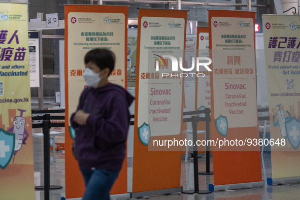 A women walks pass signs for the Sinovac CoronaVac Inactivated Vaccine by China Biotechnology company, Sinovac Biotech Ltd.,at a Covid-19 va...