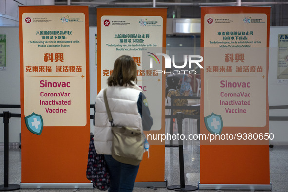 A women looks at signs for the Sinovac CoronaVac Inactivated Vaccine by China Biotechnology company, Sinovac Biotech Ltd.,at a Covid-19 vacc...