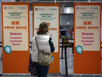 A women looks at signs for the Sinovac CoronaVac Inactivated Vaccine by China Biotechnology company, Sinovac Biotech Ltd.,at a Covid-19 vacc...