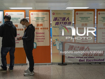 People lining up next to signs for the Sinovac CoronaVac Inactivated Vaccine by China Biotechnology company, Sinovac Biotech Ltd.,at a Covid...