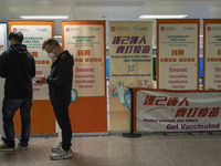 People lining up next to signs for the Sinovac CoronaVac Inactivated Vaccine by China Biotechnology company, Sinovac Biotech Ltd.,at a Covid...