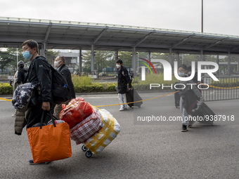 Travelers from China wearing face mask with luggages arrived in Shenzhen Bay Port on January 4, 2023 in Hong Kong, China. According to Local...