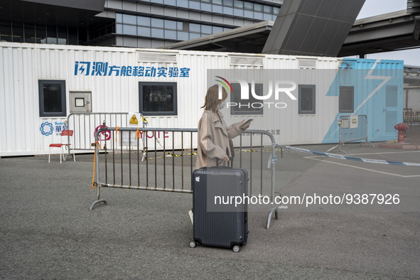 Travelers from China wearing face mask with luggages arrived in Shenzhen Bay Port on January 4, 2023 in Hong Kong, China. According to Local...