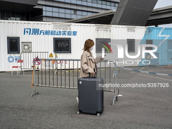 Travelers from China wearing face mask with luggages arrived in Shenzhen Bay Port on January 4, 2023 in Hong Kong, China. According to Local...