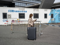 Travelers from China wearing face mask with luggages arrived in Shenzhen Bay Port on January 4, 2023 in Hong Kong, China. According to Local...