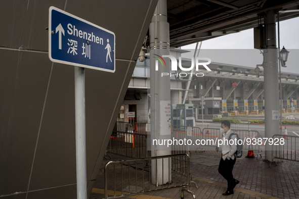 A man walks pass sign pointing to Shenzhen in Shenzhen Bay Port on January 4, 2023 in Hong Kong, China. According to Local Media Reports,  t...