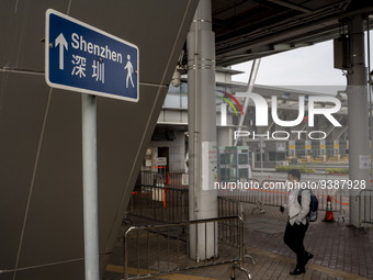 A man walks pass sign pointing to Shenzhen in Shenzhen Bay Port on January 4, 2023 in Hong Kong, China. According to Local Media Reports,  t...