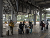 Travelers from China wearing face mask with luggages arrived in Shenzhen Bay Port on January 4, 2023 in Hong Kong, China. According to Local...