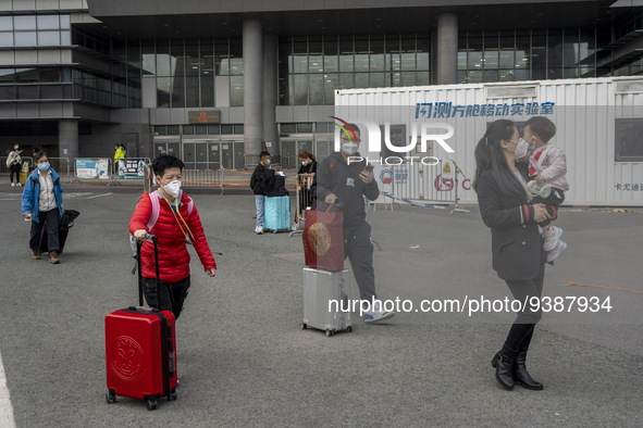 Travelers from China wearing face mask with luggages arrived in Shenzhen Bay Port on January 4, 2023 in Hong Kong, China. According to Local...