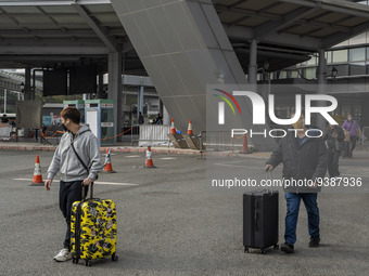 Travelers from China wearing face mask with luggages arrived in Shenzhen Bay Port on January 4, 2023 in Hong Kong, China. According to Local...