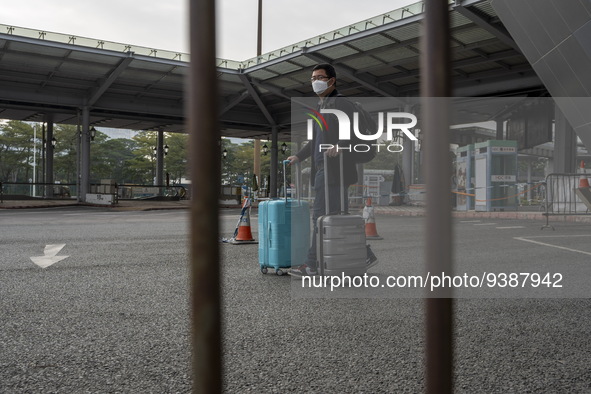 Travelers from China wearing face mask with luggages arrived in Shenzhen Bay Port on January 4, 2023 in Hong Kong, China. According to Local...