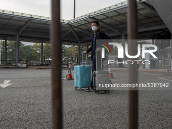 Travelers from China wearing face mask with luggages arrived in Shenzhen Bay Port on January 4, 2023 in Hong Kong, China. According to Local...