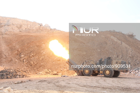 Locally made shells are launched by Free Syrian Army fighters towards the Sheikh Maqsud neighbourhood of the northern Syrian city of Aleppo...