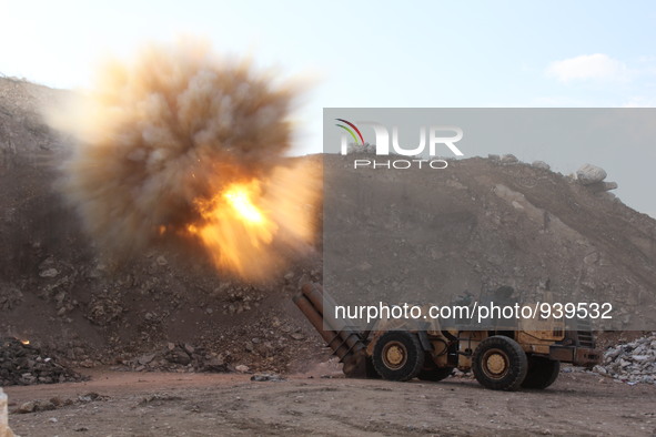 Locally made shells are launched by Free Syrian Army fighters towards the Sheikh Maqsud neighbourhood of the northern Syrian city of Aleppo...