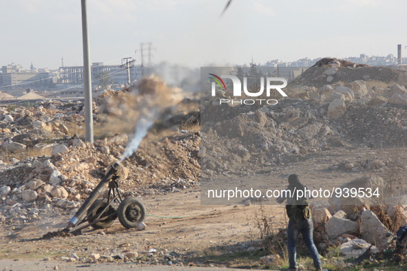 Locally made shells are launched by Free Syrian Army fighters towards the Sheikh Maqsud neighbourhood of the northern Syrian city of Aleppo...