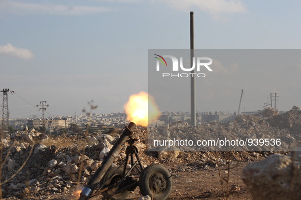 Locally made shells are launched by Free Syrian Army fighters towards the Sheikh Maqsud neighbourhood of the northern Syrian city of Aleppo...