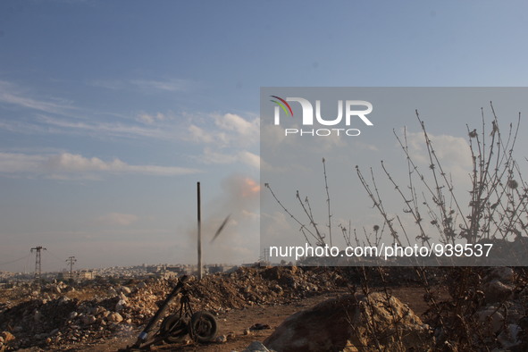 Locally made shells are launched by Free Syrian Army fighters towards the Sheikh Maqsud neighbourhood of the northern Syrian city of Aleppo...