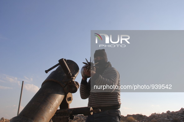 Free Syrian Army fighters prepare mortar shells towards the Sheikh Maqsud neighbourhood of the northern Syrian city of Aleppo on December 2,...