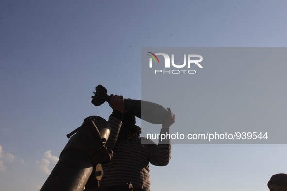 Free Syrian Army fighters prepare mortar shells towards the Sheikh Maqsud neighbourhood of the northern Syrian city of Aleppo on December 2,...