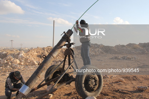 Free Syrian Army fighters prepare mortar shells towards the Sheikh Maqsud neighbourhood of the northern Syrian city of Aleppo on December 2,...