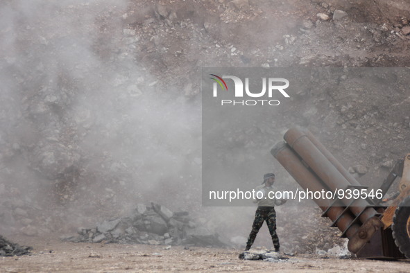 Free Syrian Army fighters prepare mortar shells towards the Sheikh Maqsud neighbourhood of the northern Syrian city of Aleppo on December 2,...