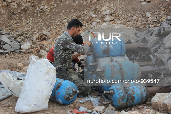 Free Syrian Army fighters prepare mortar shells towards the Sheikh Maqsud neighbourhood of the northern Syrian city of Aleppo on December 2,...