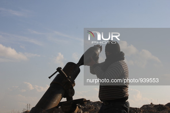 Free Syrian Army fighters prepare mortar shells towards the Sheikh Maqsud neighbourhood of the northern Syrian city of Aleppo on December 2,...