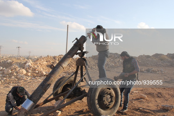 Free Syrian Army fighters prepare mortar shells towards the Sheikh Maqsud neighbourhood of the northern Syrian city of Aleppo on December 2,...