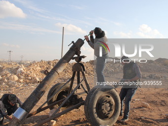 Free Syrian Army fighters prepare mortar shells towards the Sheikh Maqsud neighbourhood of the northern Syrian city of Aleppo on December 2,...