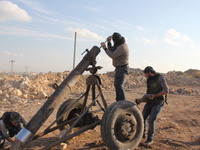 Free Syrian Army fighters prepare mortar shells towards the Sheikh Maqsud neighbourhood of the northern Syrian city of Aleppo on December 2,...