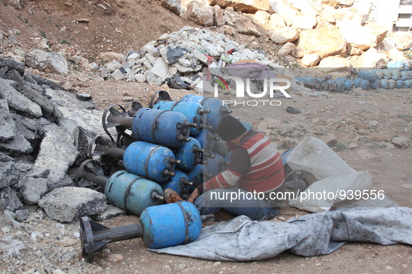 Free Syrian Army fighters prepare mortar shells towards the Sheikh Maqsud neighbourhood of the northern Syrian city of Aleppo on December 2,...