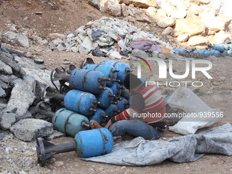 Free Syrian Army fighters prepare mortar shells towards the Sheikh Maqsud neighbourhood of the northern Syrian city of Aleppo on December 2,...