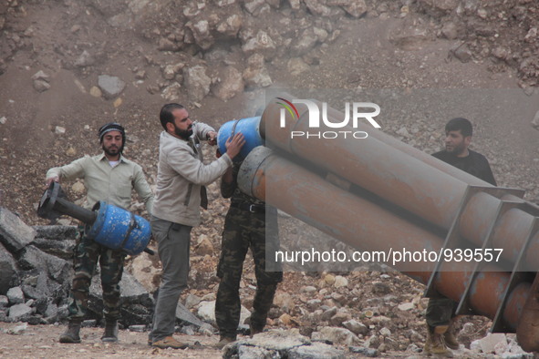 Free Syrian Army fighters prepare mortar shells towards the Sheikh Maqsud neighbourhood of the northern Syrian city of Aleppo on December 2,...