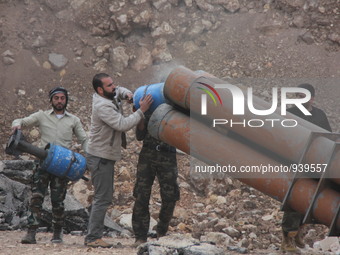 Free Syrian Army fighters prepare mortar shells towards the Sheikh Maqsud neighbourhood of the northern Syrian city of Aleppo on December 2,...