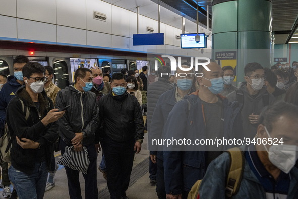 Travelers wearing face masks arriving at Lok Ma Chau MTR Station on January 8, 2023 in Hong Kong, China. Hong Kong today resumes quarantine...