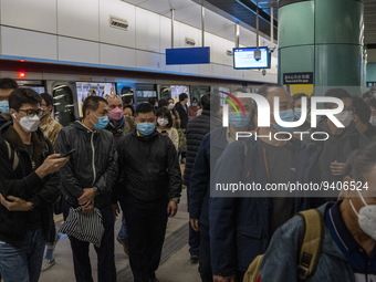 Travelers wearing face masks arriving at Lok Ma Chau MTR Station on January 8, 2023 in Hong Kong, China. Hong Kong today resumes quarantine...