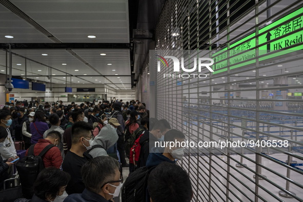 Travelers wearing face masks waiting for the gates to open at the Lok Ma Chau Border Crossing on January 8, 2023 in Hong Kong, China. Hong K...