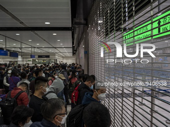 Travelers wearing face masks waiting for the gates to open at the Lok Ma Chau Border Crossing on January 8, 2023 in Hong Kong, China. Hong K...