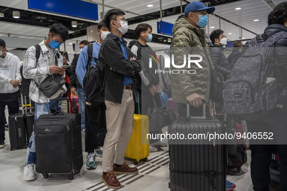 Travelers wearing face masks waiting for the gates to open at the Lok Ma Chau Border Crossing on January 8, 2023 in Hong Kong, China. Hong K...