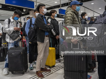 Travelers wearing face masks waiting for the gates to open at the Lok Ma Chau Border Crossing on January 8, 2023 in Hong Kong, China. Hong K...