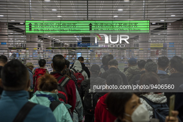 Travelers wearing face masks waiting for the gates to open at the Lok Ma Chau Border Crossing on January 8, 2023 in Hong Kong, China. Hong K...