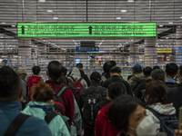 Travelers wearing face masks waiting for the gates to open at the Lok Ma Chau Border Crossing on January 8, 2023 in Hong Kong, China. Hong K...