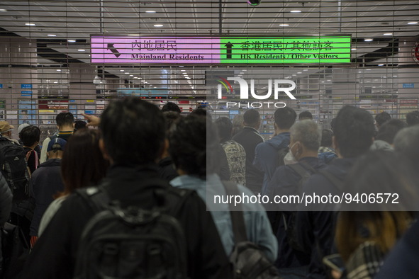 Travelers wearing face masks waiting for the gates to open at the Lok Ma Chau Border Crossing on January 8, 2023 in Hong Kong, China. Hong K...