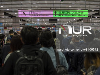 Travelers wearing face masks waiting for the gates to open at the Lok Ma Chau Border Crossing on January 8, 2023 in Hong Kong, China. Hong K...