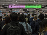 Travelers wearing face masks waiting for the gates to open at the Lok Ma Chau Border Crossing on January 8, 2023 in Hong Kong, China. Hong K...